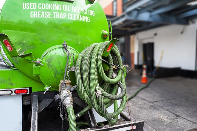 large truck pumping grease trap at a restaurant in Crockett